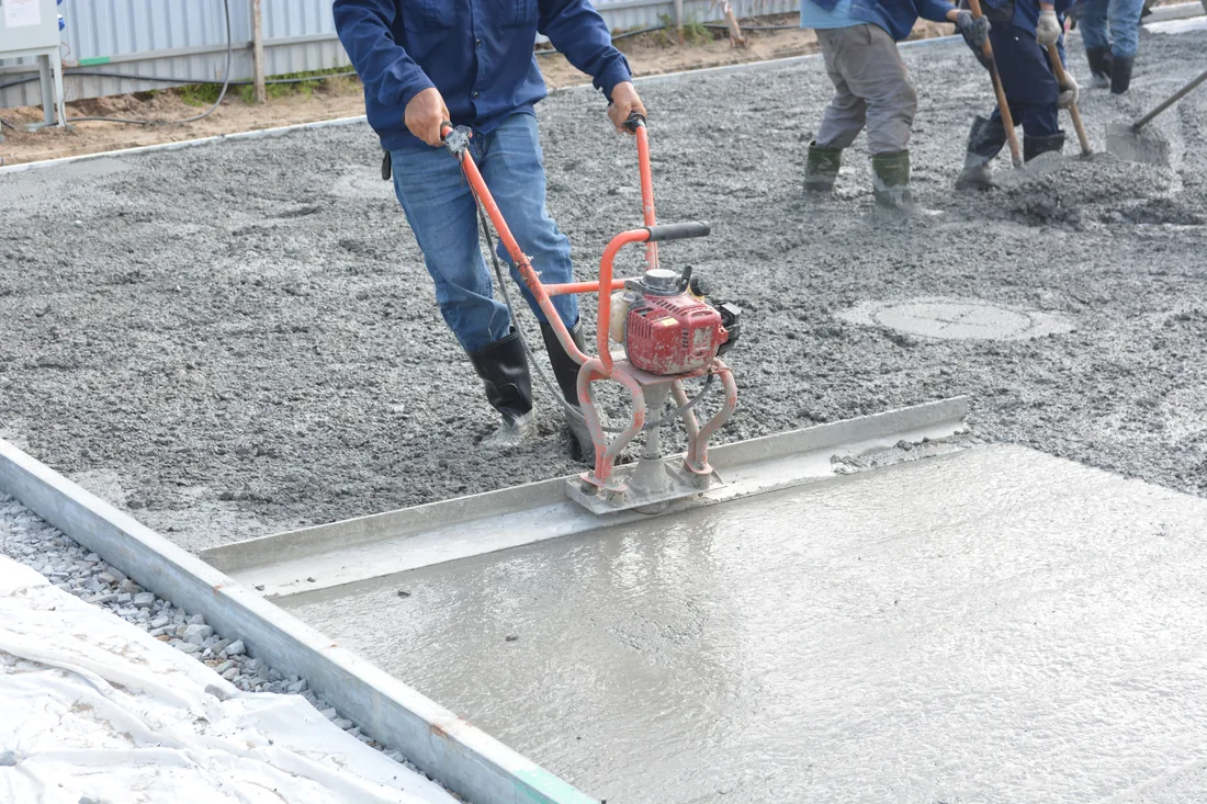 An Ironleaf crew working a concrete pour with power tools