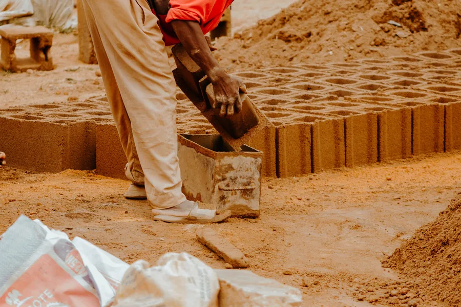 A worker forming blockwork on a construction site